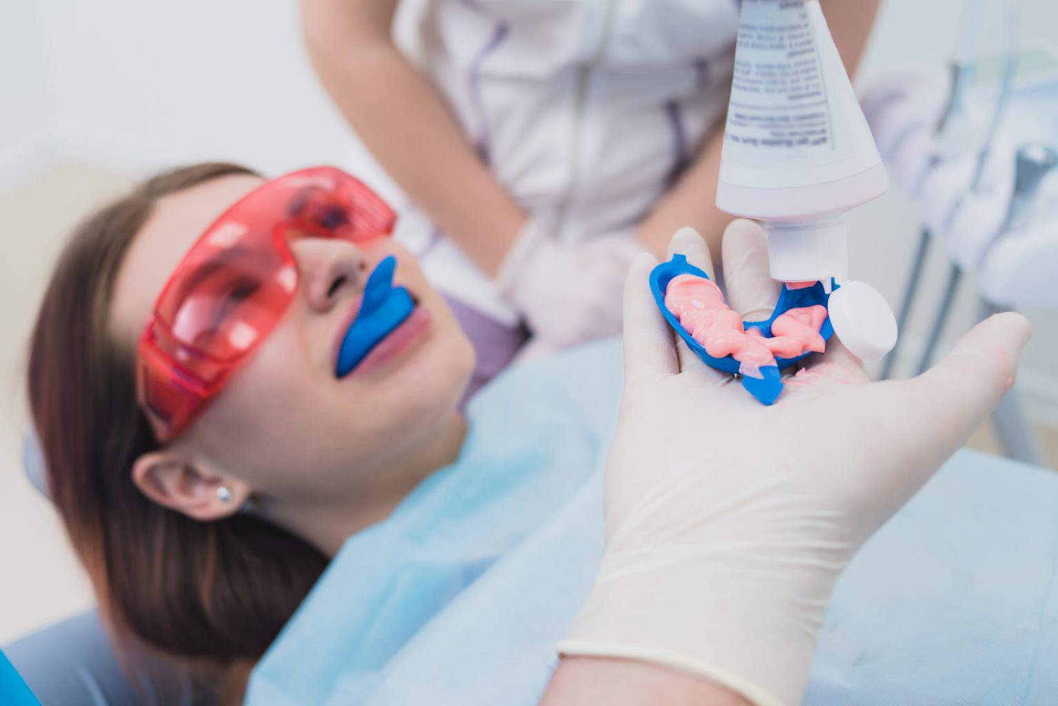 Doctor Orthodontist Performs A Procedure For Cleaning Teeth